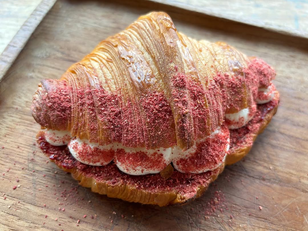 Strawberry cream croissant dusted with freeze-dried berry powder
