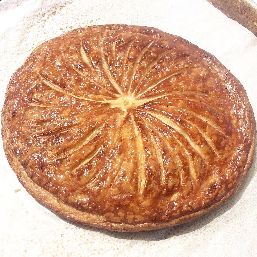 Baked galette des rois with sunburst scoring, deeply golden