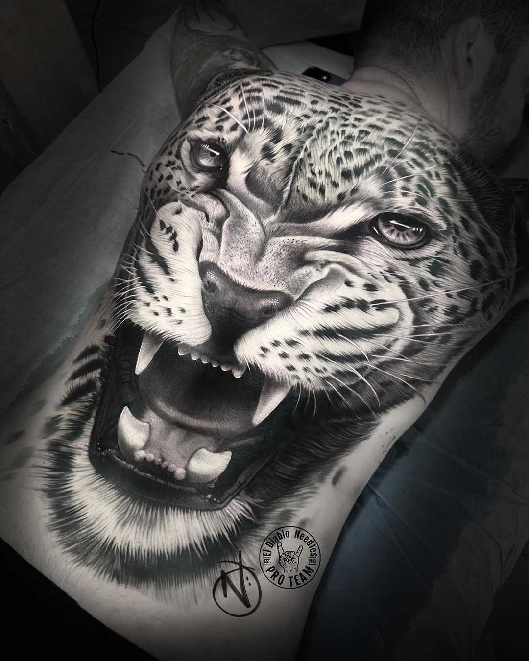 Hyperreal roaring leopard full-back tattoo